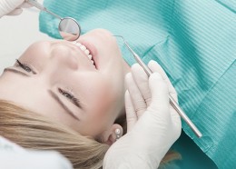 Half-length portrait of young fair-haired lovely girl sitting on a reception at the dentist. Top view